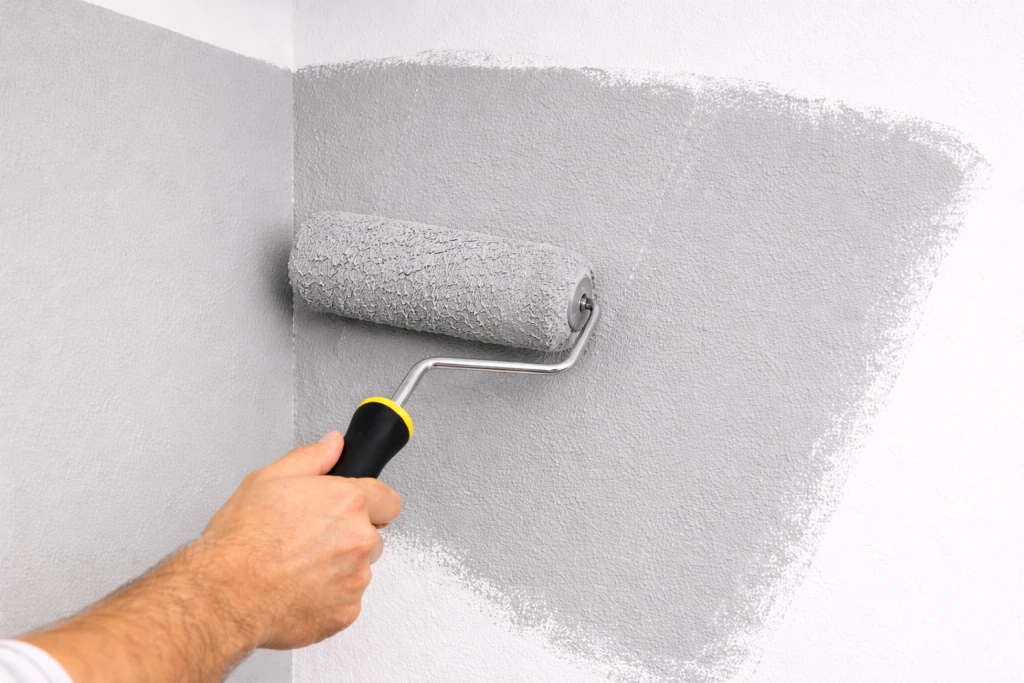 Roller overlapping wet paint edge showing proper technique to avoid lap marks
